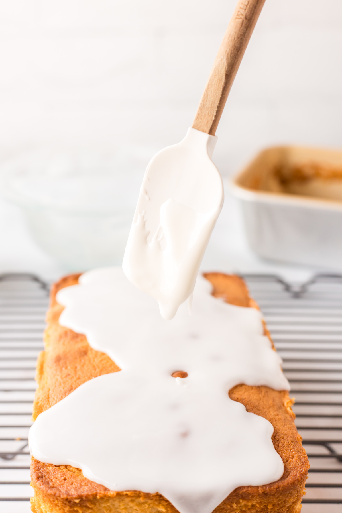 drizzling glaze onto lemon loaf