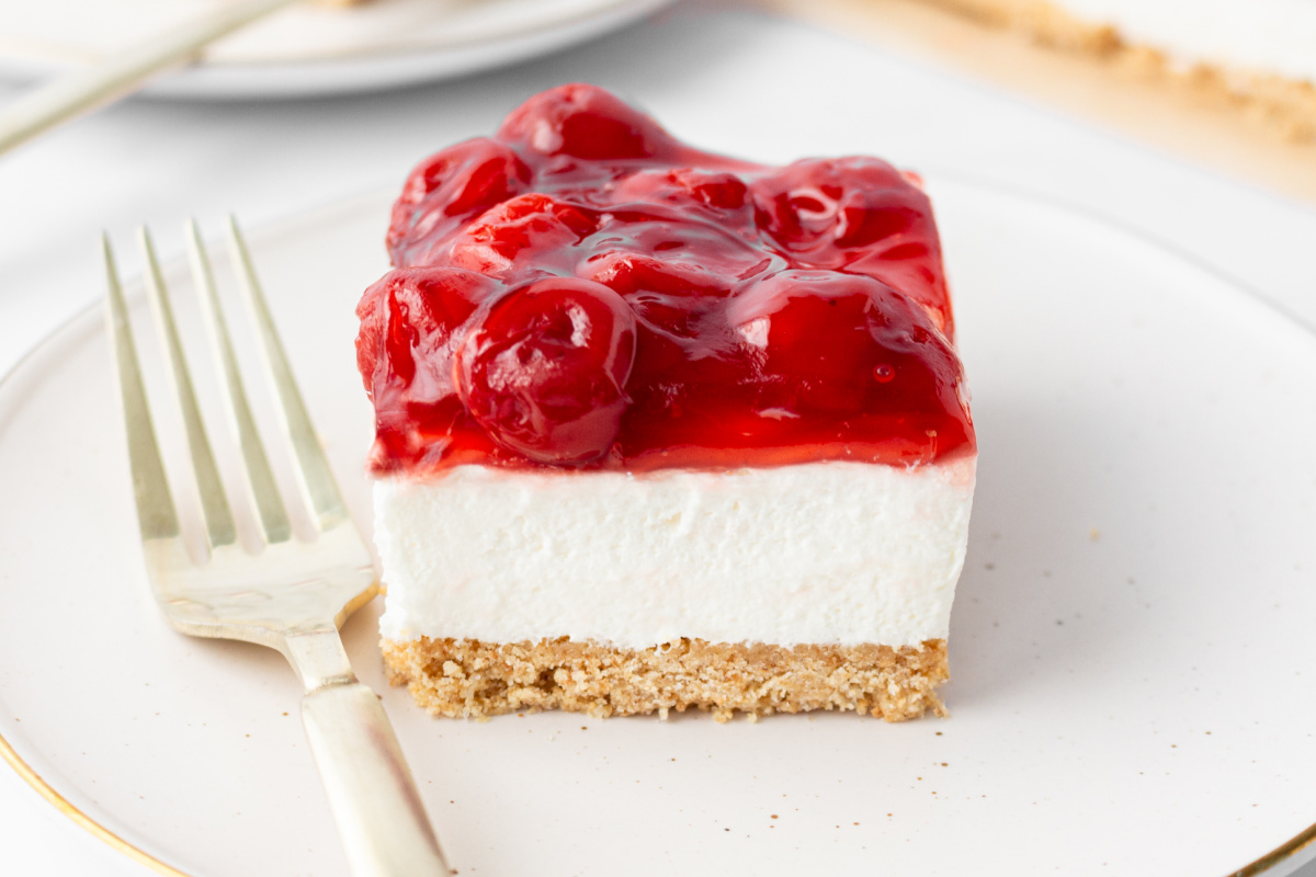 piece of old fashioned cherry delight on a plate with a fork