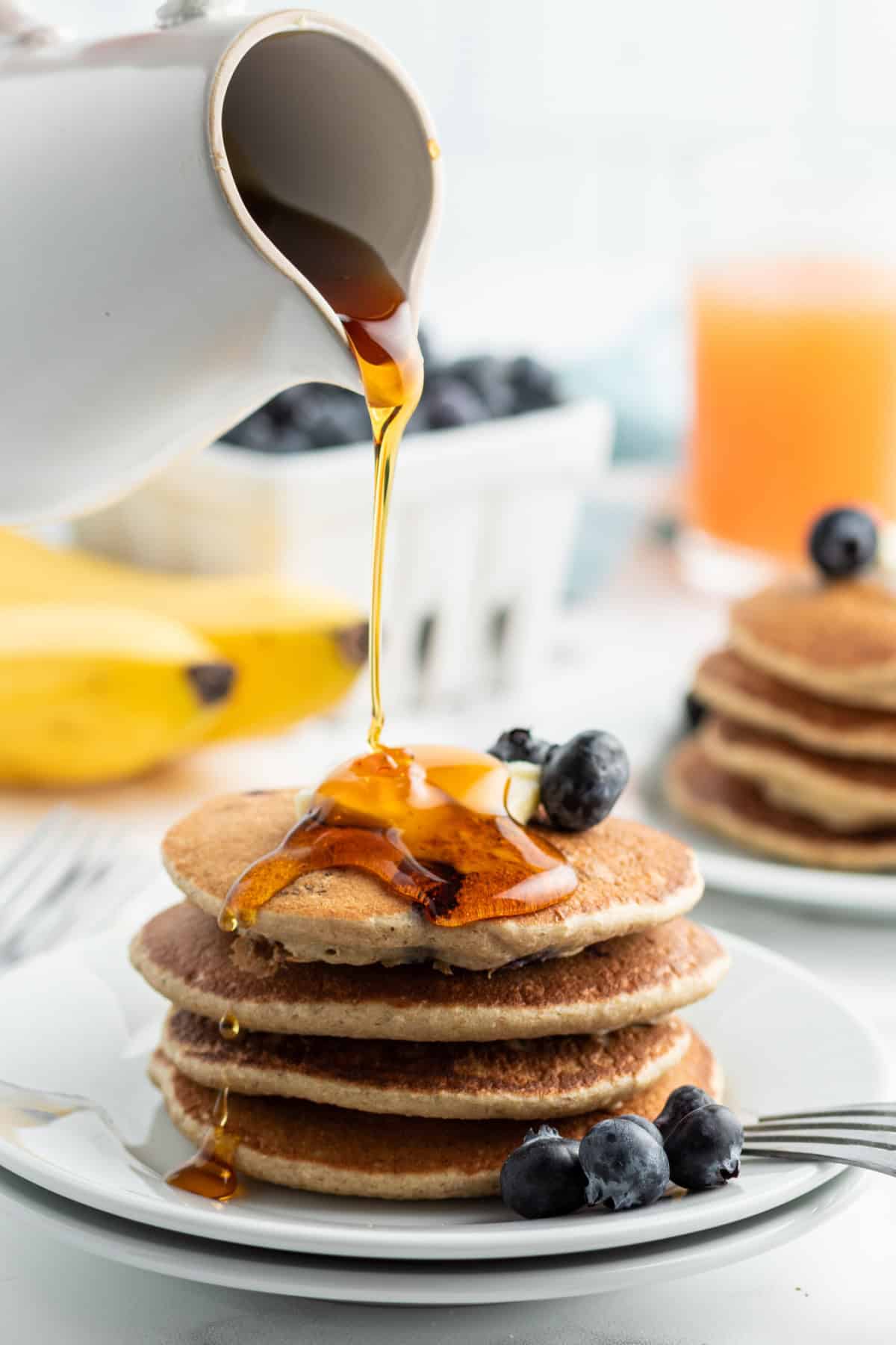 Oatmeal Blender Pancakes recipe from RecipeBoy.com : banana blender pancakes : banana blueberry pancakes : gluten free pancakes syrup pouring over stack of oatmeal blender pancakes