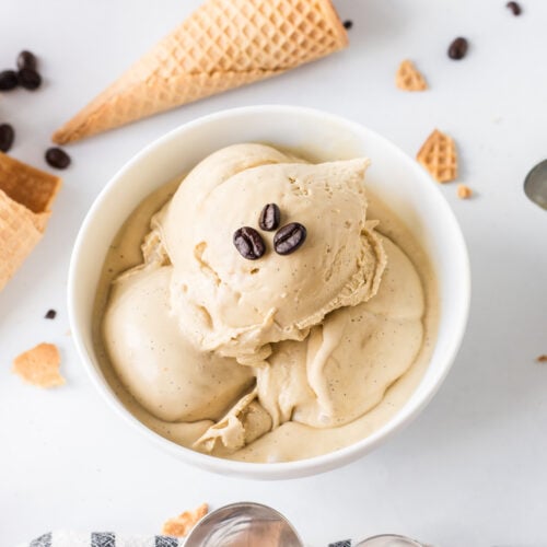bowl of scoops of coffee ice cream with coffee beans on top