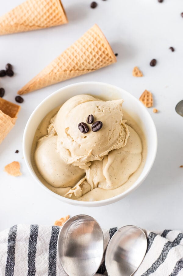 bowl of scoops of coffee ice cream with coffee beans on top