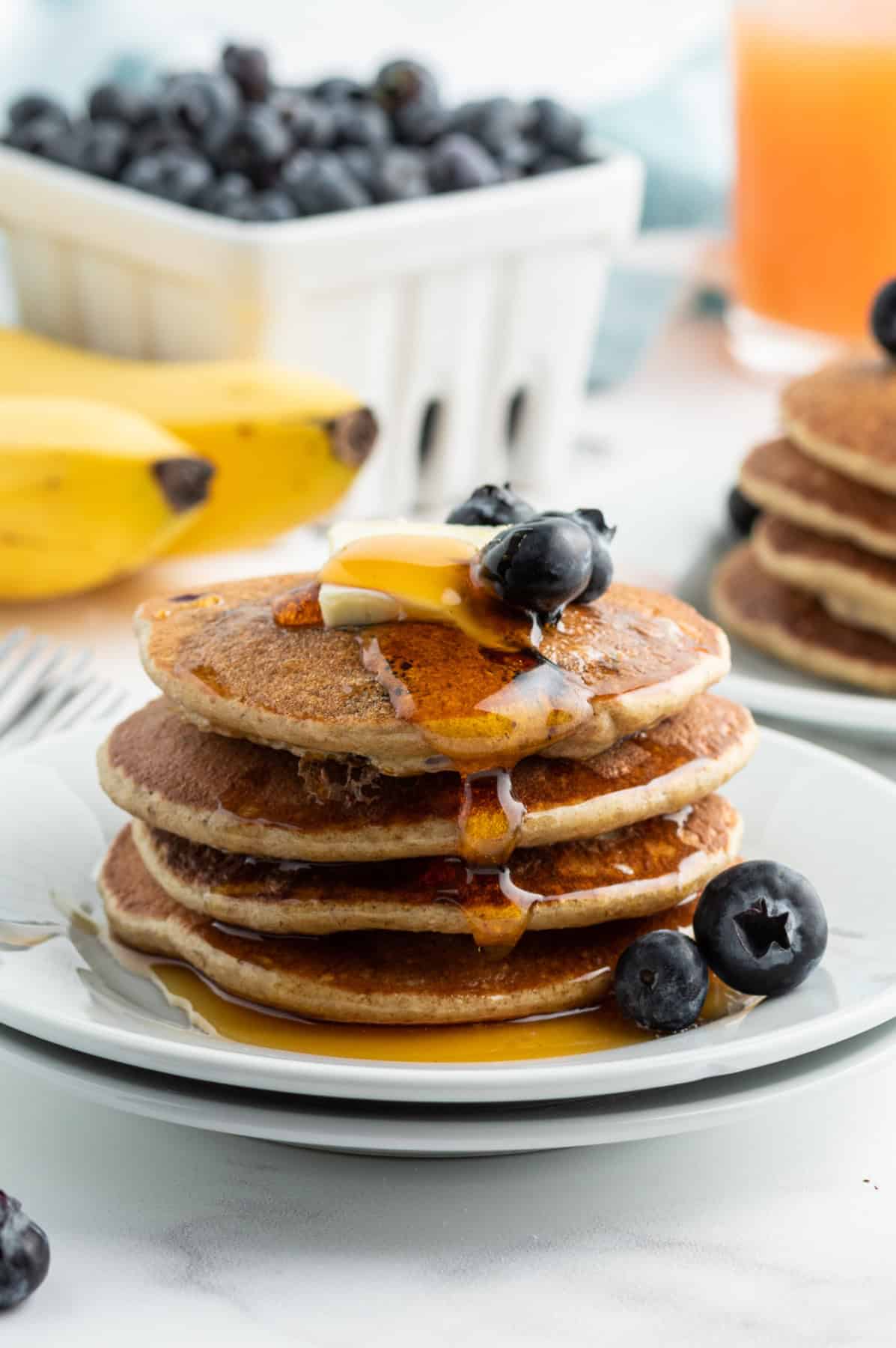 stack of oatmeal blender pancakes on plate with syrup