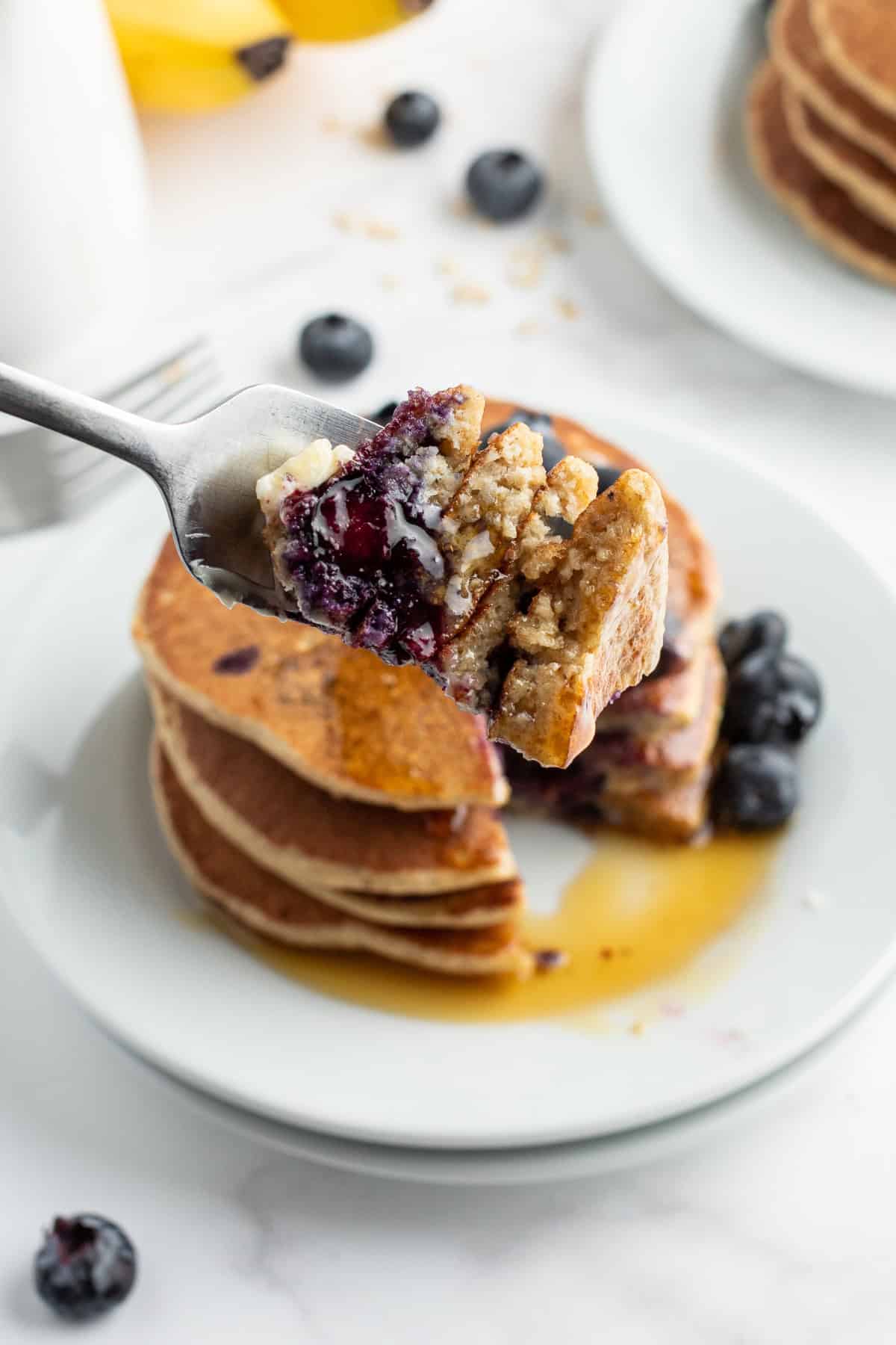 fork full of bite of oatmeal blender pancakes