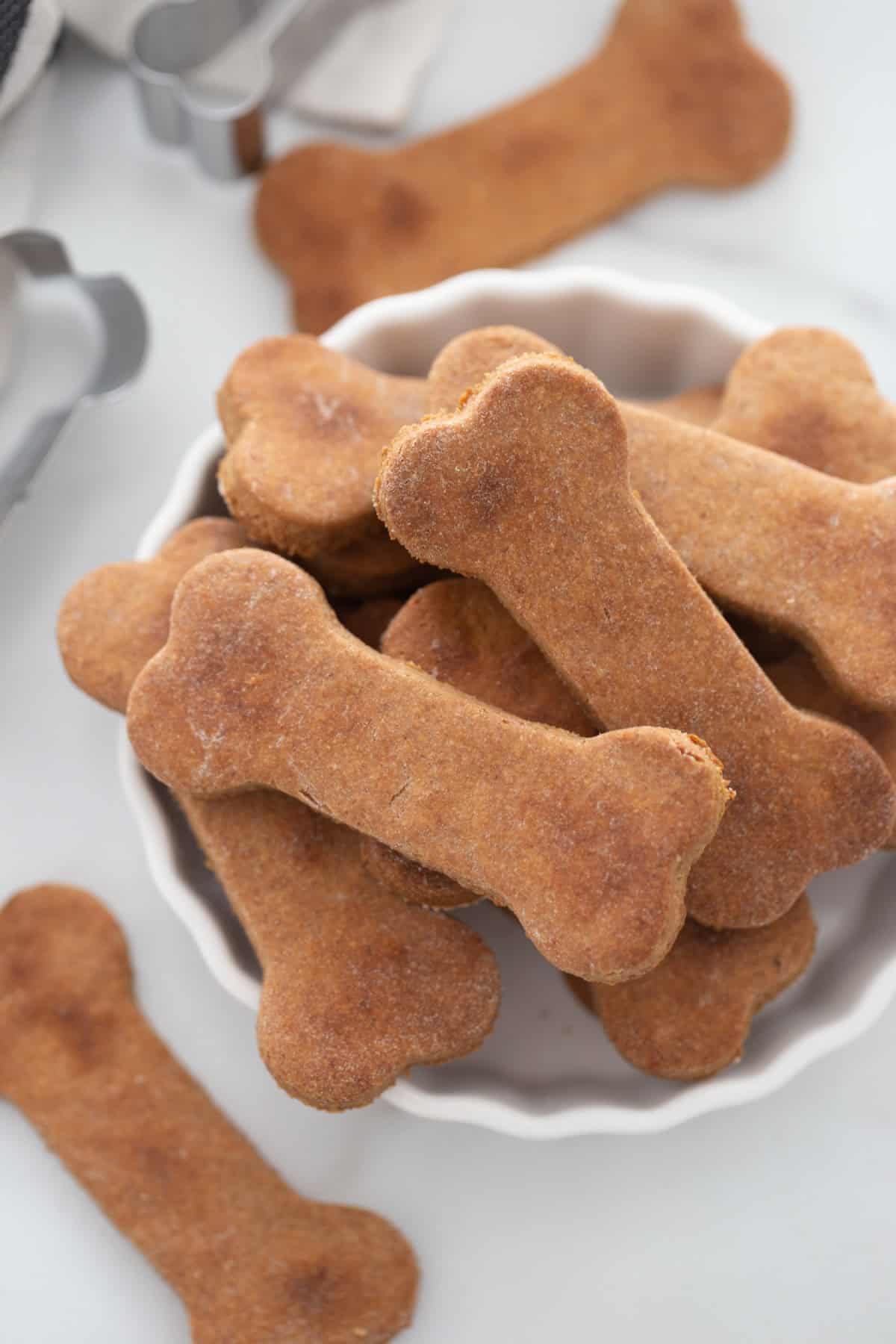 peanut butter dog biscuits displayed in overflowing bowl