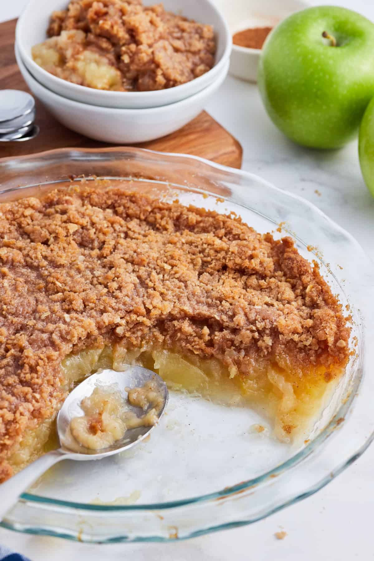 apple betty in dish with some scooped out