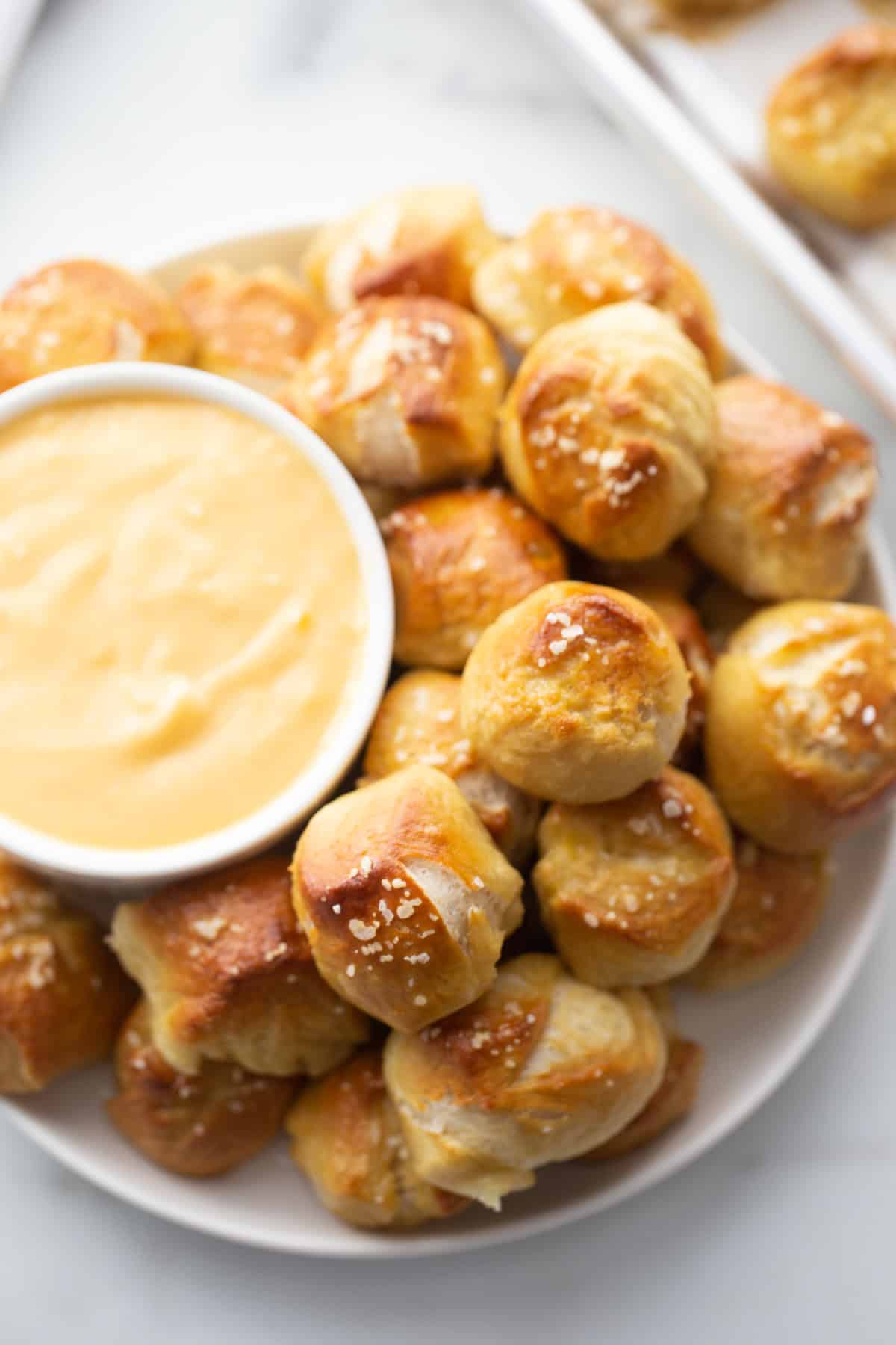 Soft Pretzel Bites with Cheese Sauce recipe from RecipeBoy.com platter of soft pretzel bites with bowl of cheese sauce