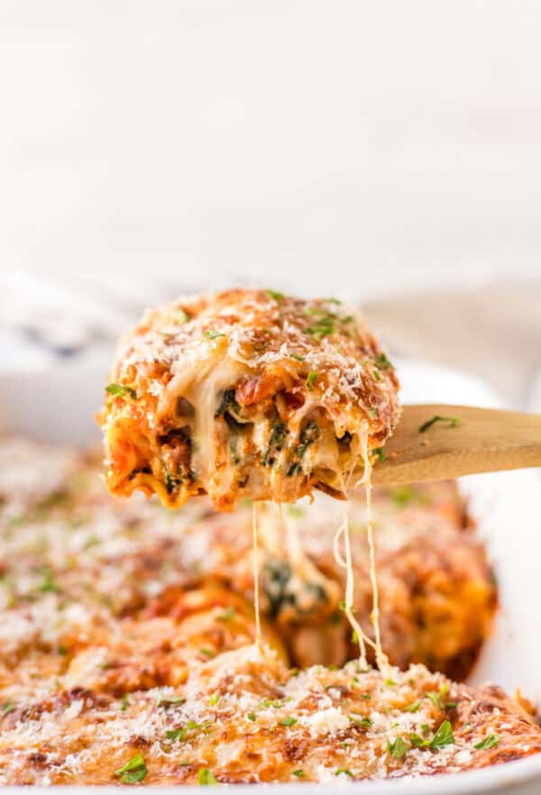 spatula picking up a spinach lasagna roll up