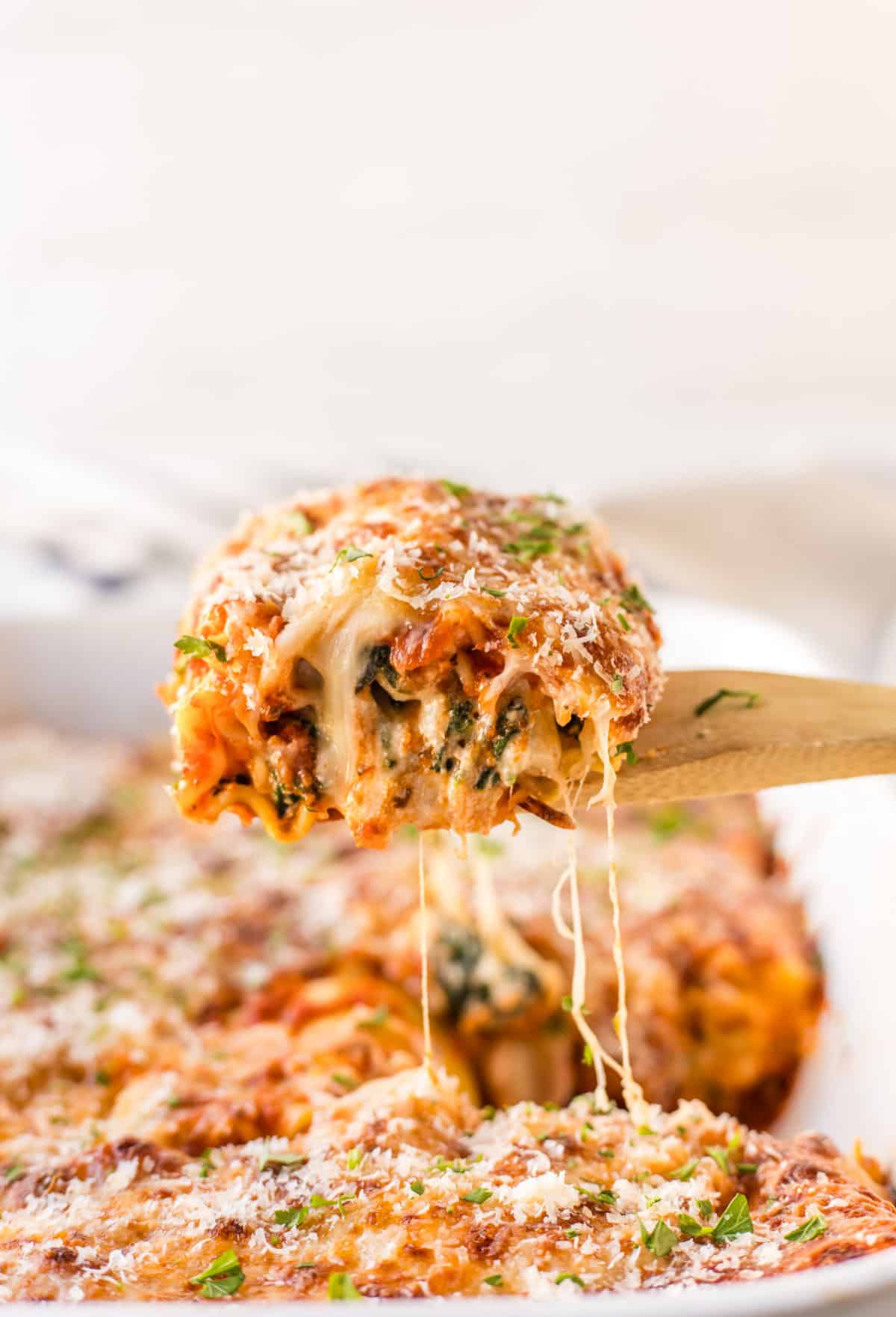 Spinach Lasagna Roll Ups recipe from RecipeBoy.com. Instead of layers, lasagna filling is rolled up into lasagna noodles and baked with marinara and cheese until hot and bubbly. spatula picking up a spinach lasagna roll up
