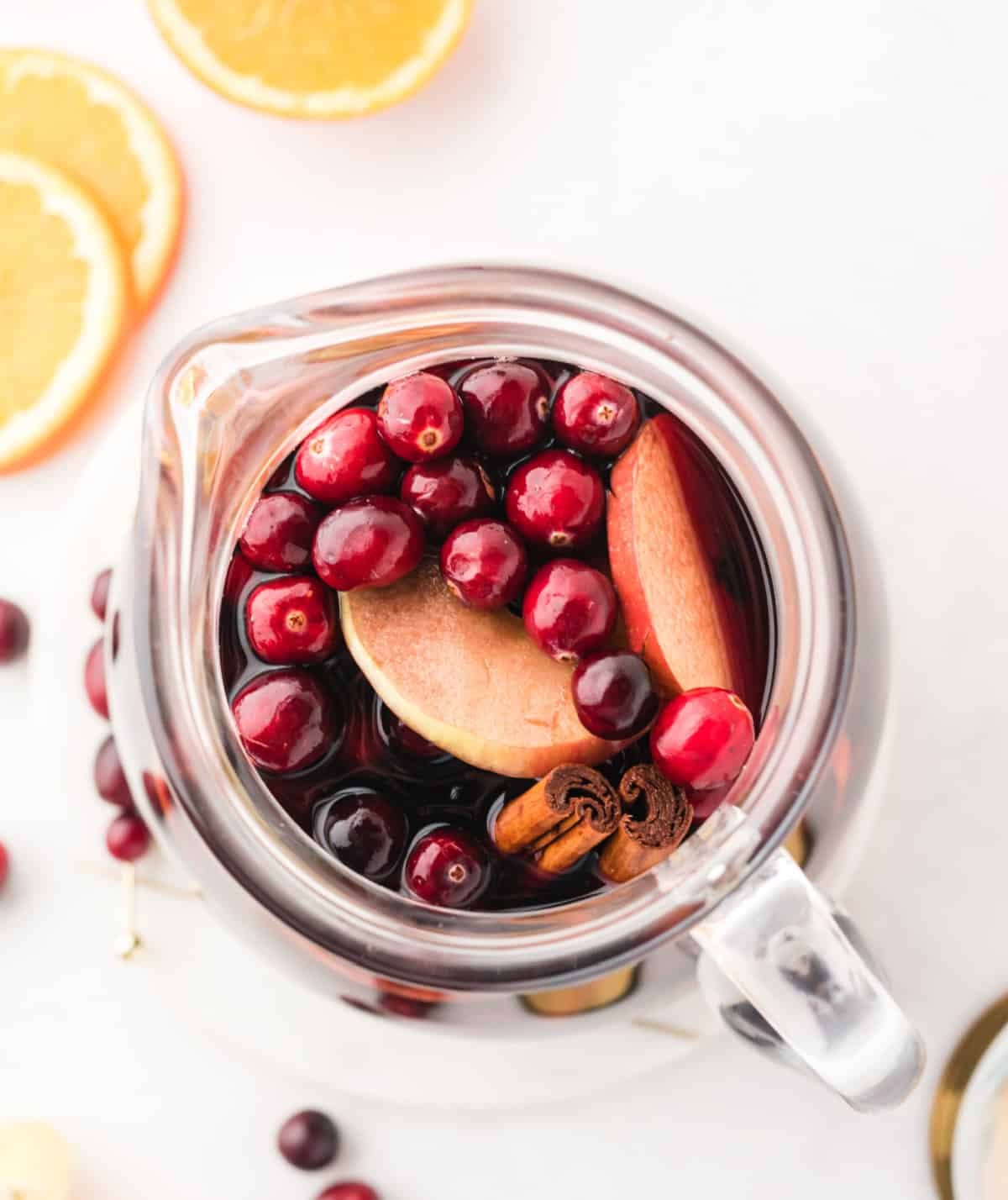 overhead shot into a pitcher of apple cranberry sangria