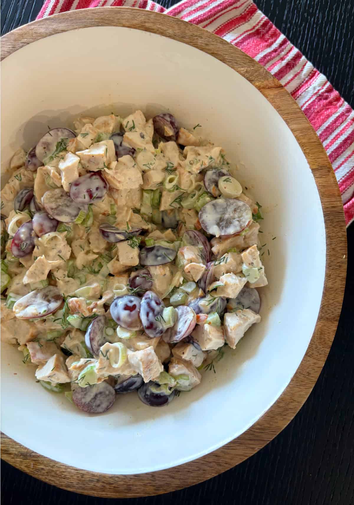 This creamy chicken salad from Pioneer Woman’s The Essential Recipes cookbook is filled with grapes, dill, and lemony dressing. A fresh, make-ahead lunch idea! bowl of chicken salad