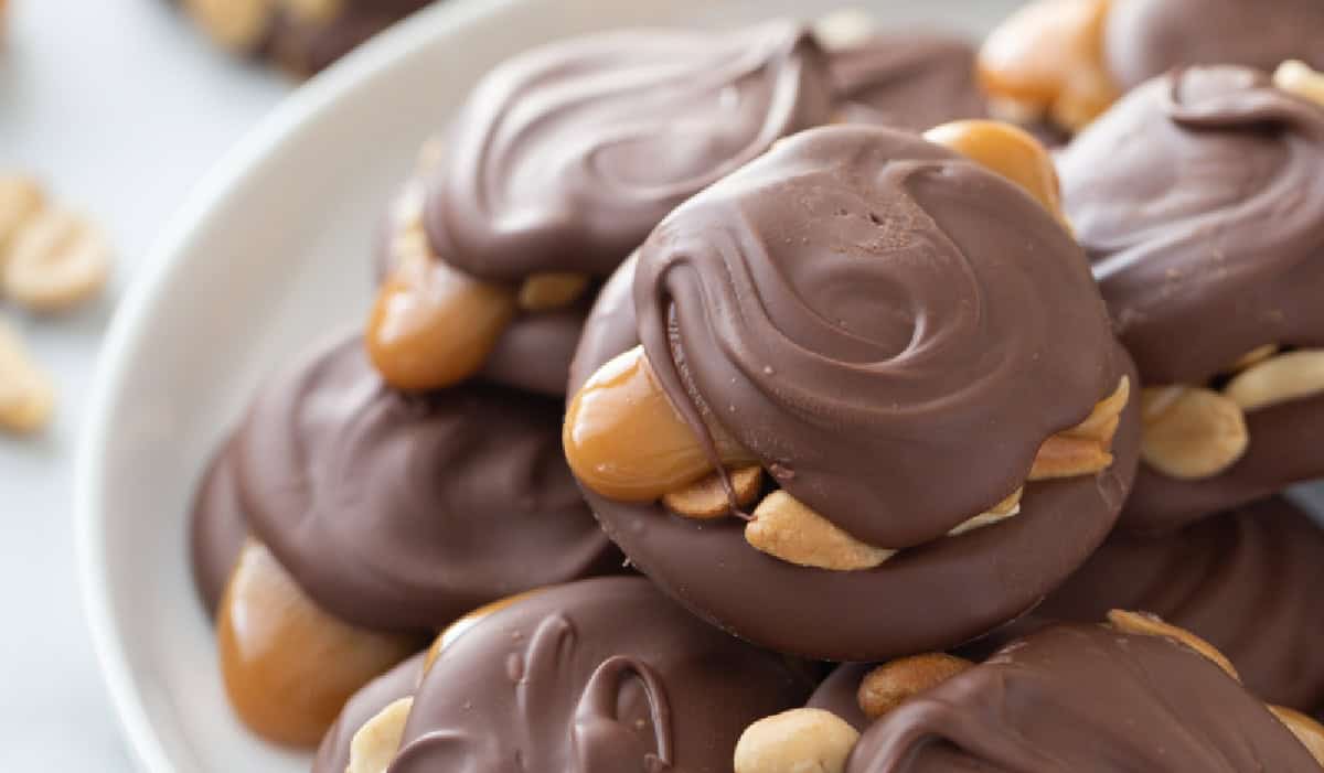 These Easy Caramel Peanut Clusters are layered with melted chocolate, roasted peanuts, and soft caramel—just like gourmet candy shop treats but so simple to make! caramel peanut clusters