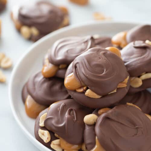 chocolate caramel peanut clusters on a plate