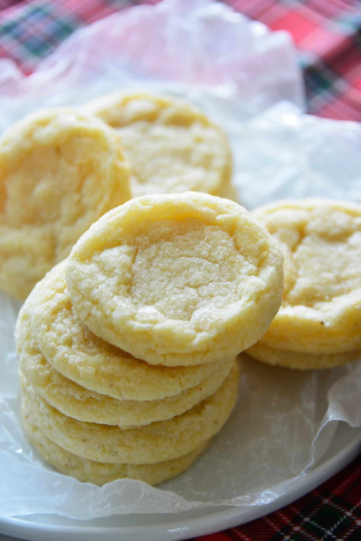 These soft and tender Eggnog Cookies taste just like classic holiday eggnog! Rolled in sugar and full of nutmeg flavor—perfect for Christmas cookie trays. stacks of freshly baked eggnog cookies