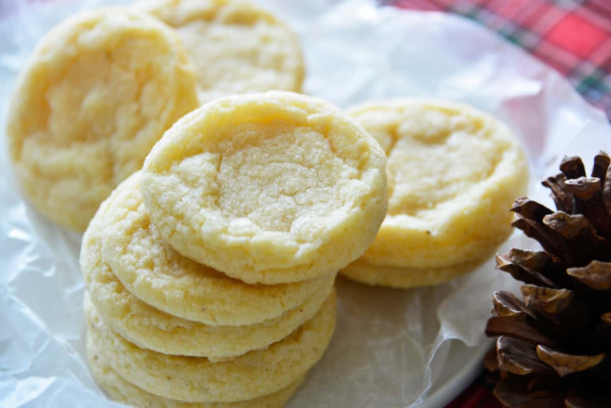 These soft and tender Eggnog Cookies taste just like classic holiday eggnog! Rolled in sugar and full of nutmeg flavor—perfect for Christmas cookie trays. stacks of eggnog cookies