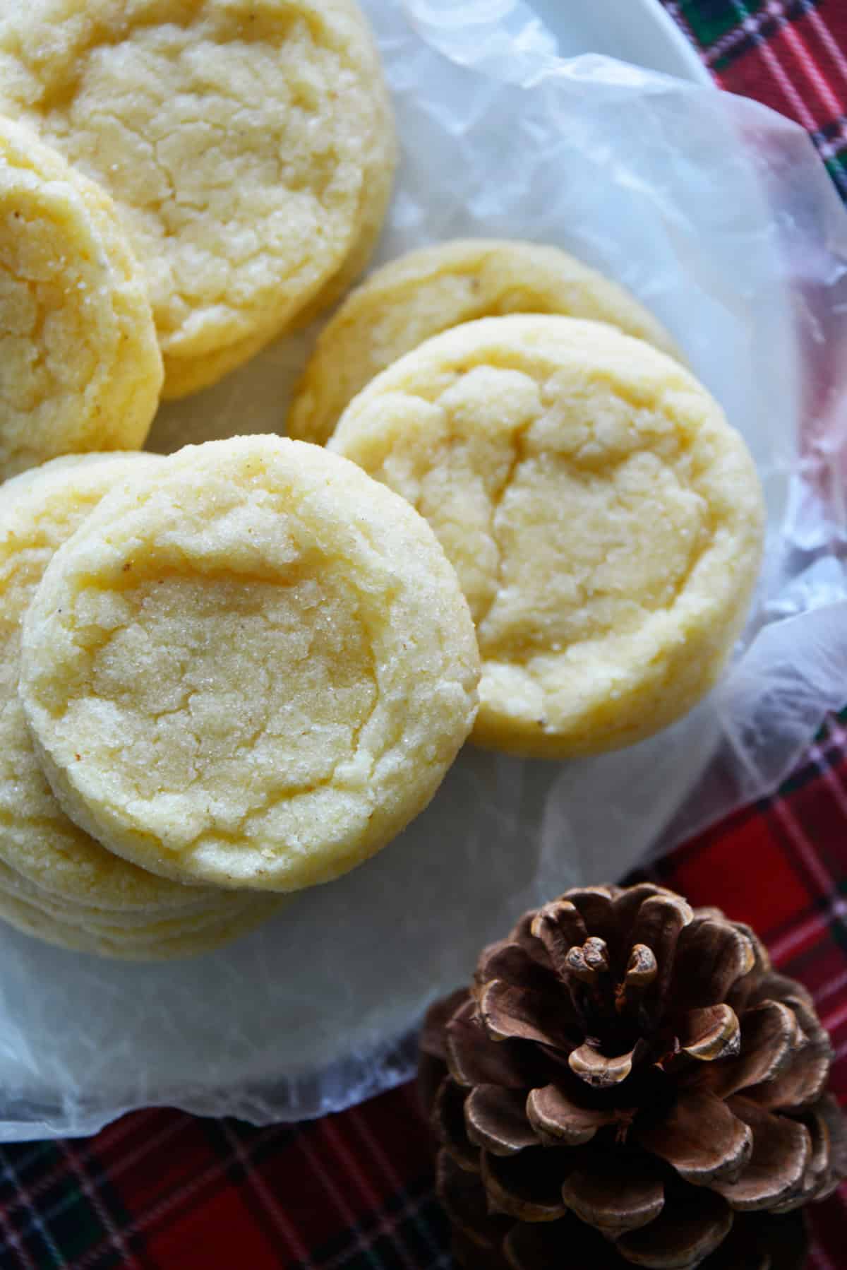These soft and tender Eggnog Cookies taste just like classic holiday eggnog! Rolled in sugar and full of nutmeg flavor—perfect for Christmas cookie trays. overhead shot of stacks of eggnog cookies