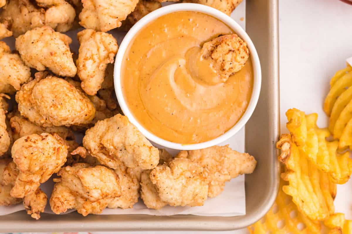 copycat chick-fil-a nuggets on pan with bowl of sauce