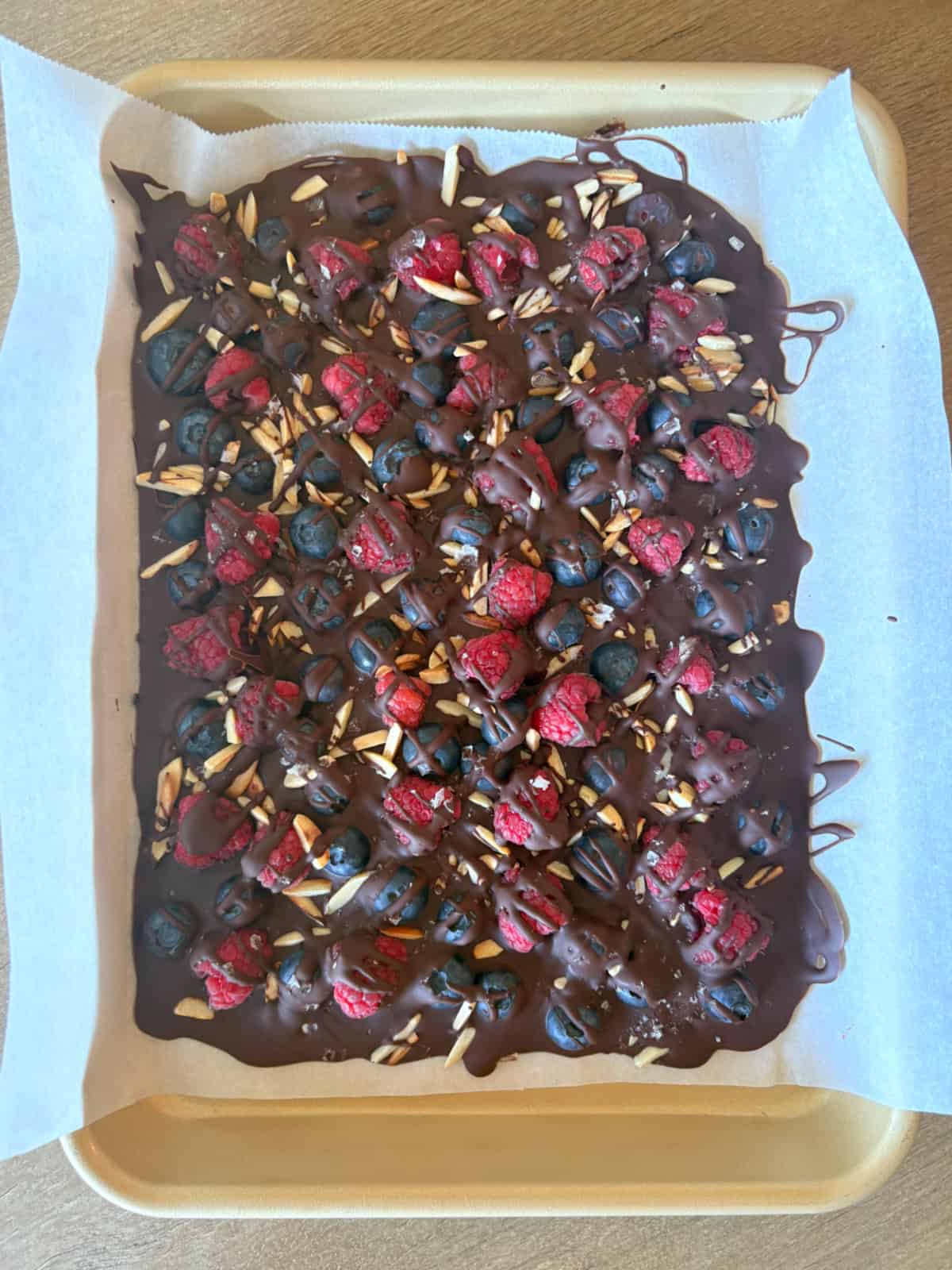 chocolate berry bark on baking sheet before breaking apart