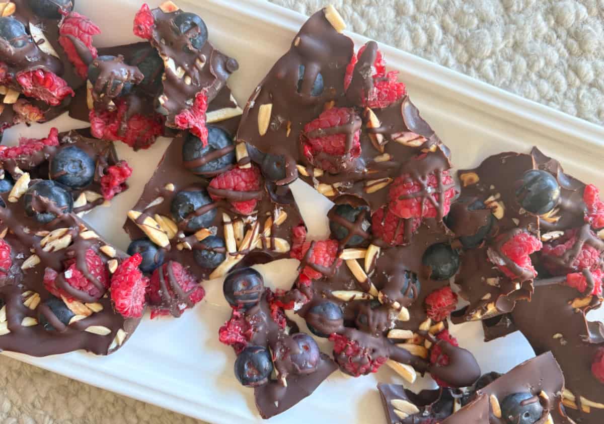chocolate berry bark pieces on a white platter