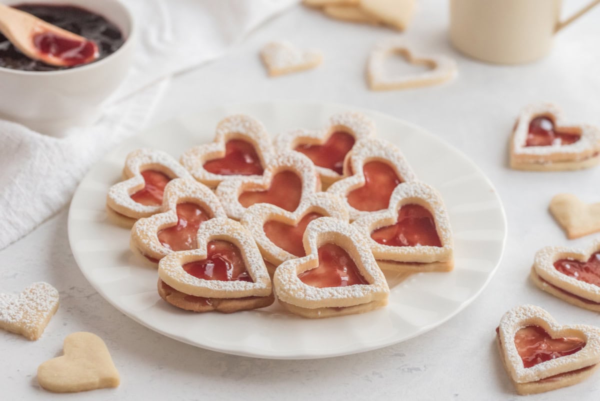 several linzer heart cookies on plate