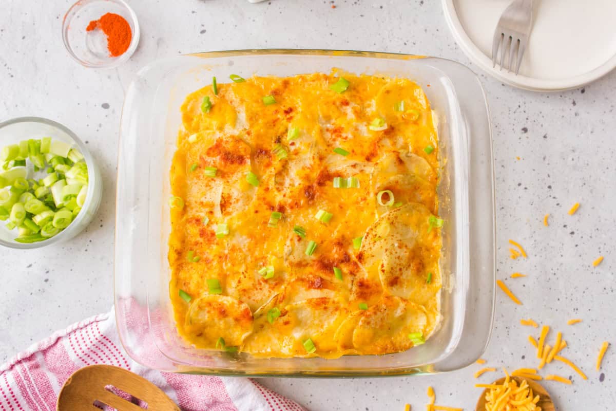 These Microwave Scalloped Potatoes are creamy, cheesy, and ready fast—no oven required! The perfect easy potato side dish. overhead shot of microwave scalloped potatoes in pan