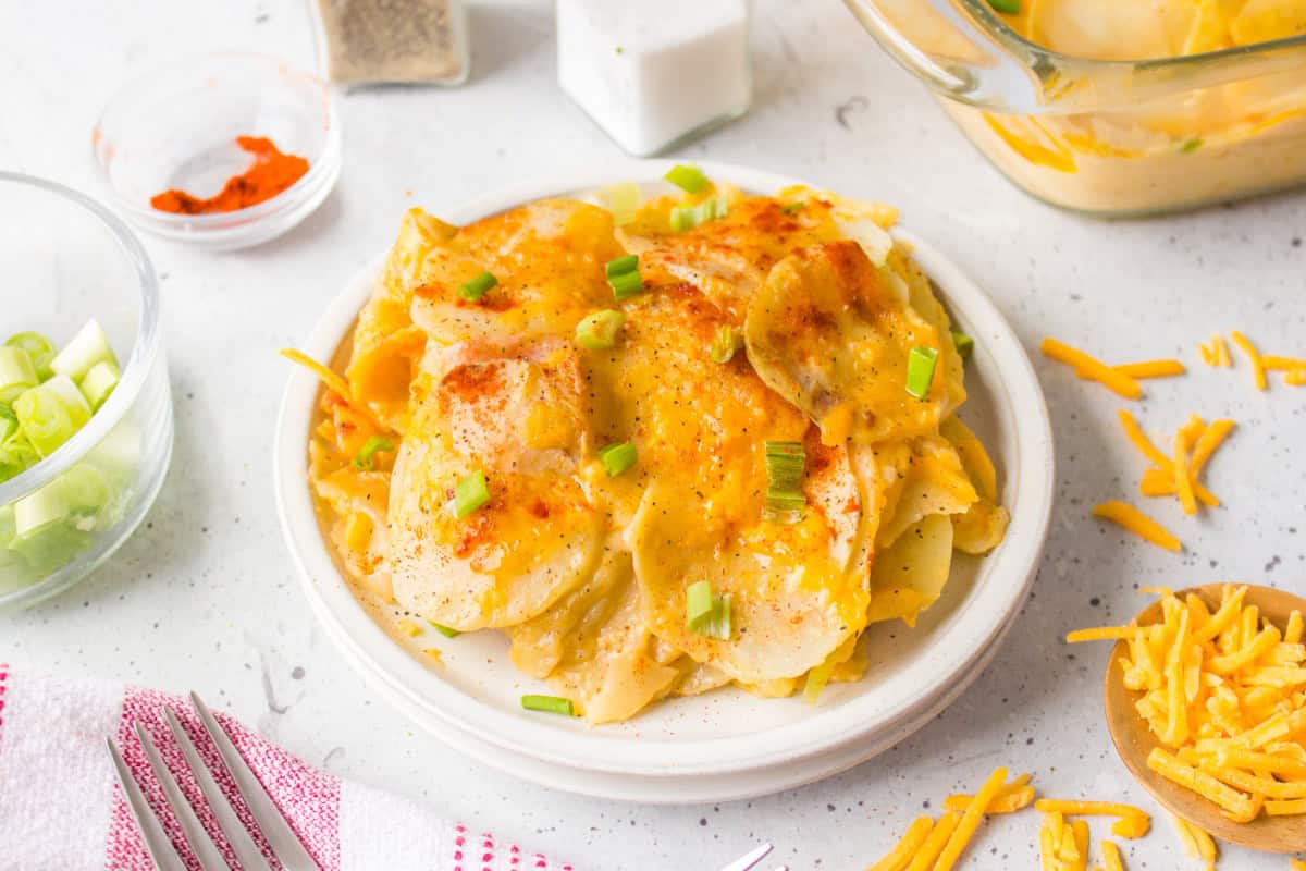 These Microwave Scalloped Potatoes are creamy, cheesy, and ready fast—no oven required! The perfect easy potato side dish. serving of microwave scalloped potatoes on plate