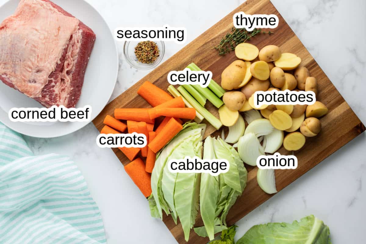 Slow Cooked Corned Beef and Cabbage is an easy, tender, and flavorful St. Patrick’s Day dinner made with brisket and hearty vegetables. ingredients displayed for making slow cooked corned beef and cabbage