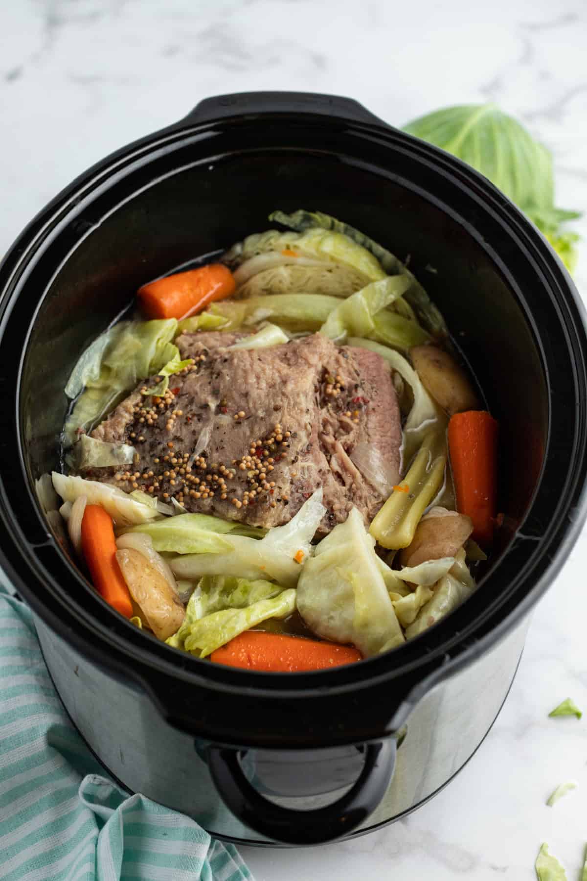 Slow Cooked Corned Beef and Cabbage is an easy, tender, and flavorful St. Patrick’s Day dinner made with brisket and hearty vegetables. slow cooked corned beef in a slow cooker