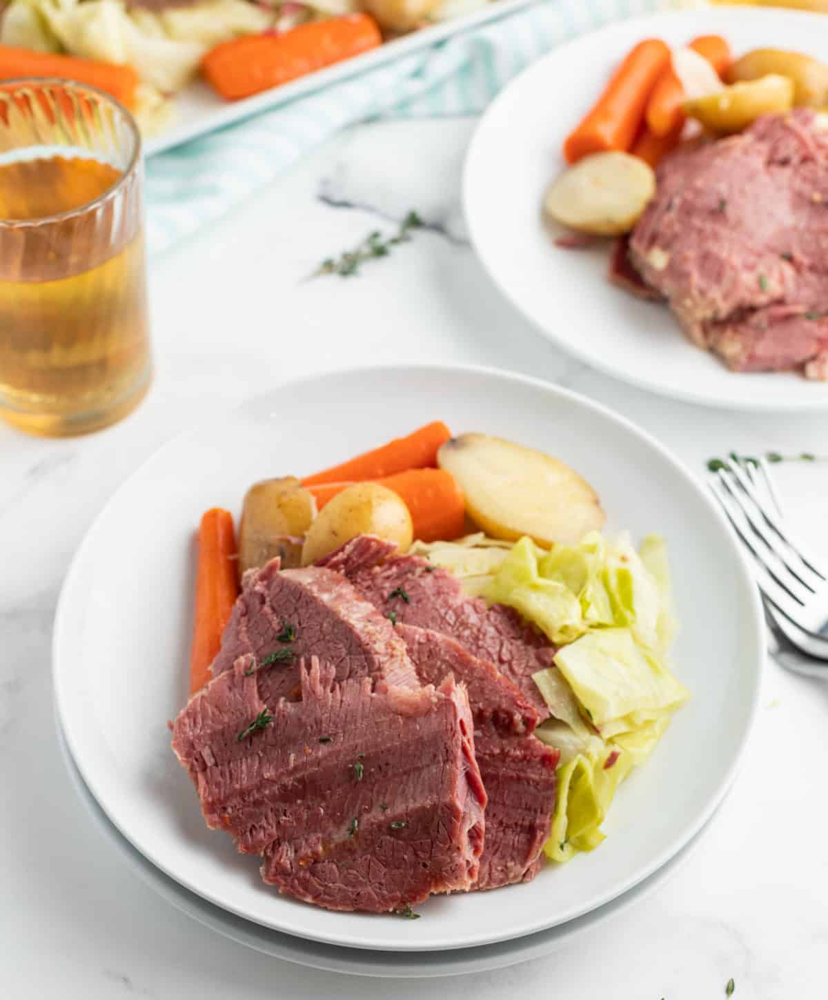 Slow Cooked Corned Beef and Cabbage is an easy, tender, and flavorful St. Patrick’s Day dinner made with brisket and hearty vegetables. serving of corned beef and cabbage dinner on a plate