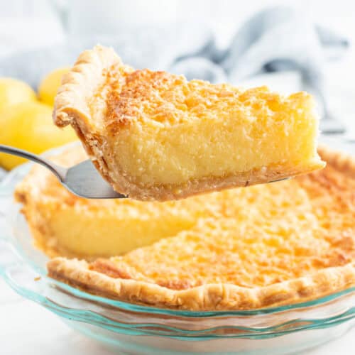 pie server with slice of lemon custard pie and rest of pie underneath