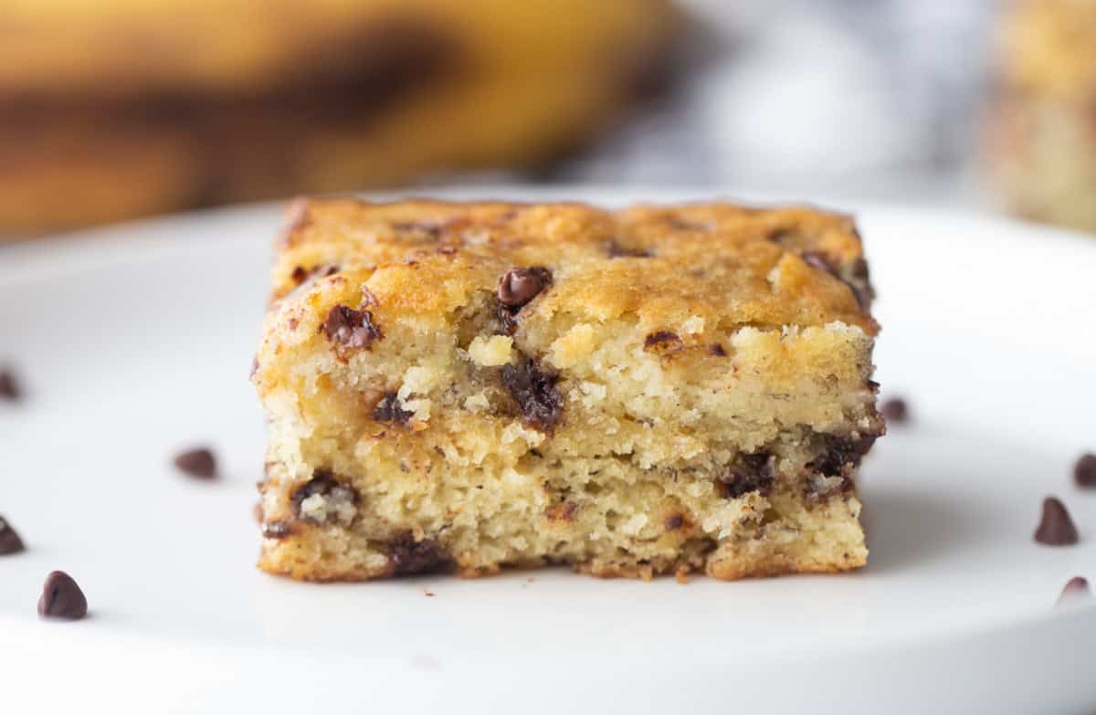 Chocolate chip banana snack cake that’s soft, moist and easy to make. A simple one-pan dessert everyone will love! piece of chocolate chip banana snack cake