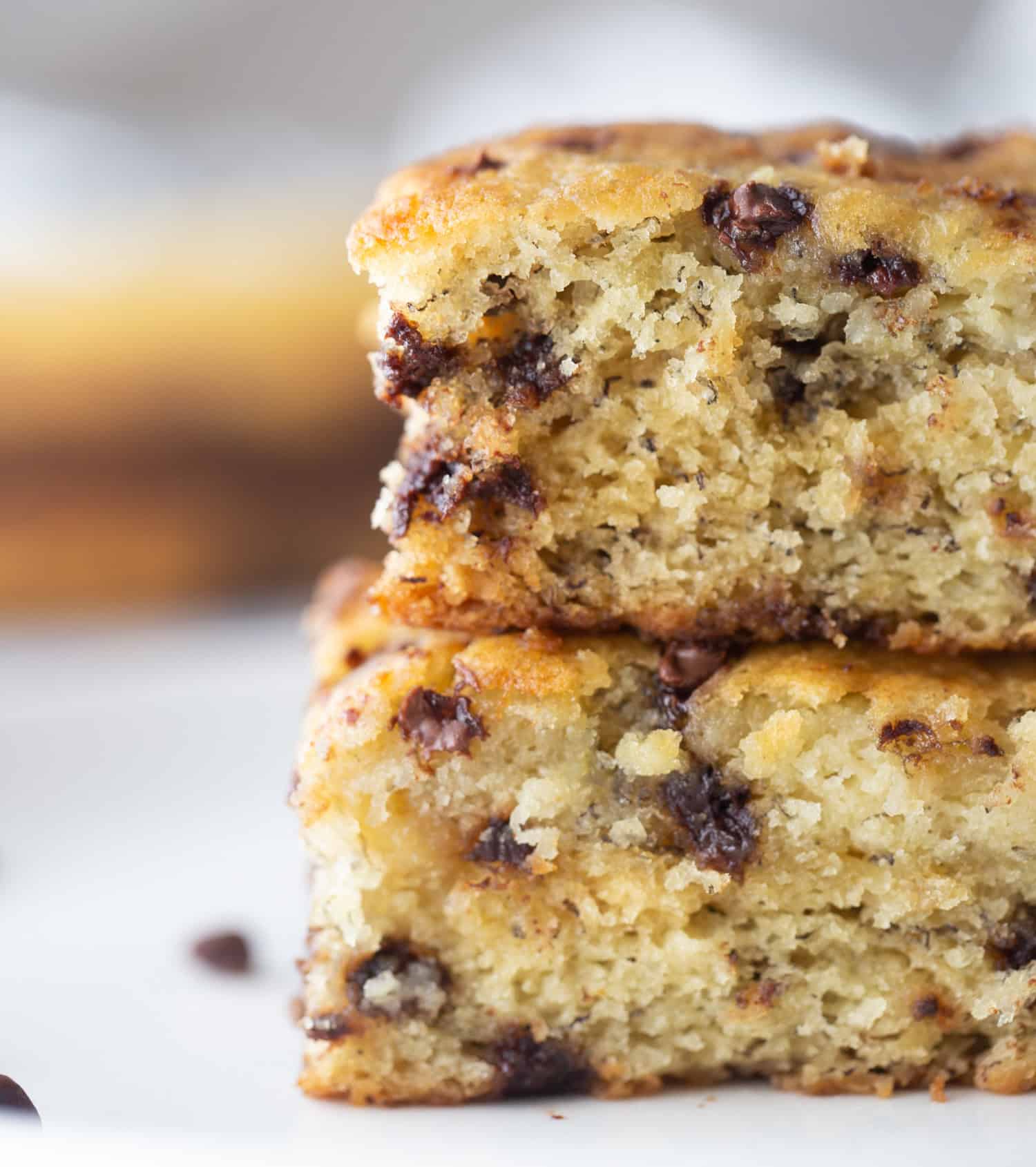 Chocolate chip banana snack cake that’s soft, moist and easy to make. A simple one-pan dessert everyone will love! two pieces chocolate chip banana snack cake stacked close up