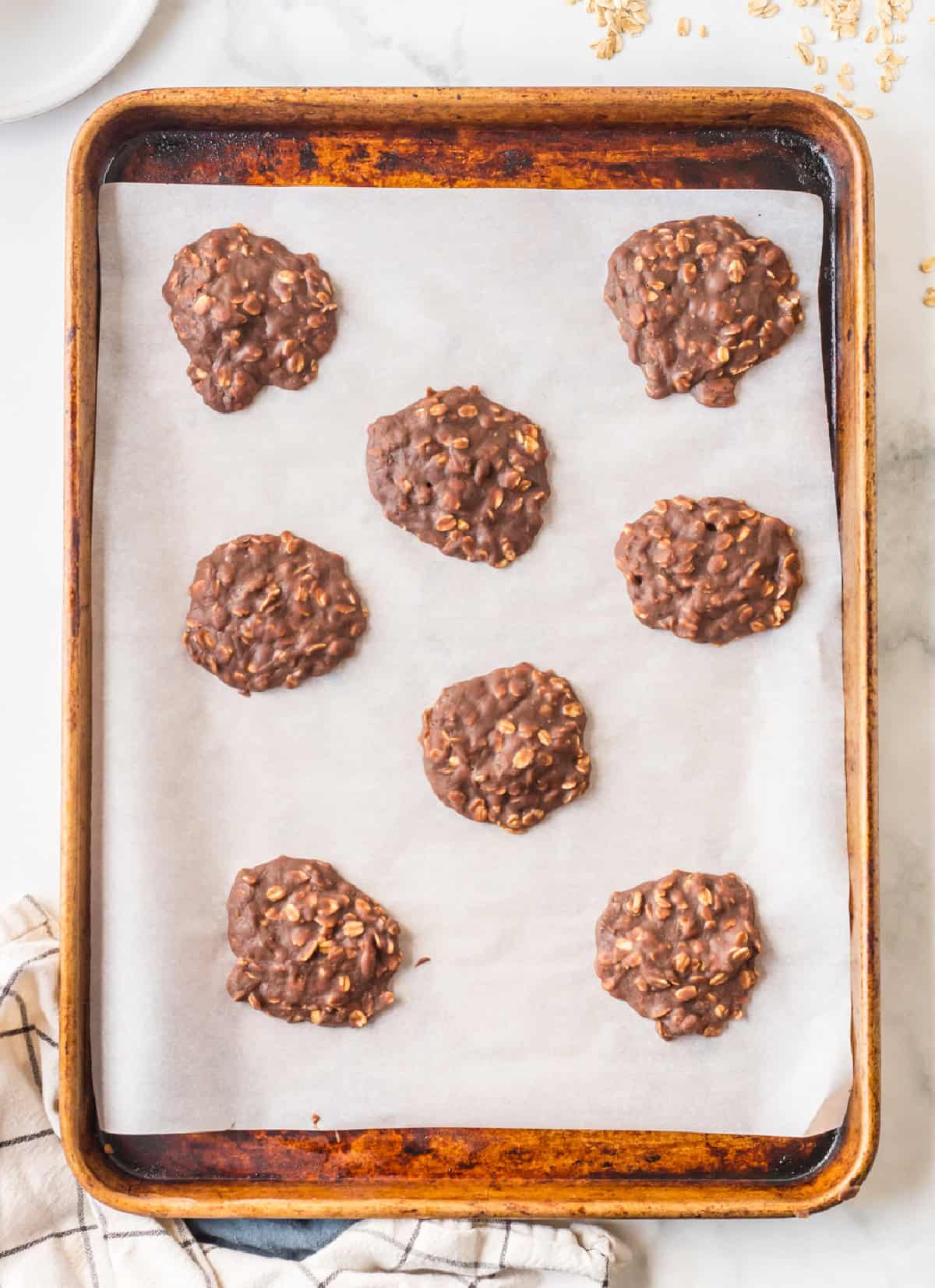 Chocolate peanut butter no bake cookies made with oats and cocoa. Easy, fudgy and perfect for a no-oven summer dessert! baking sheet with chocolate peanut butter no bake cookies