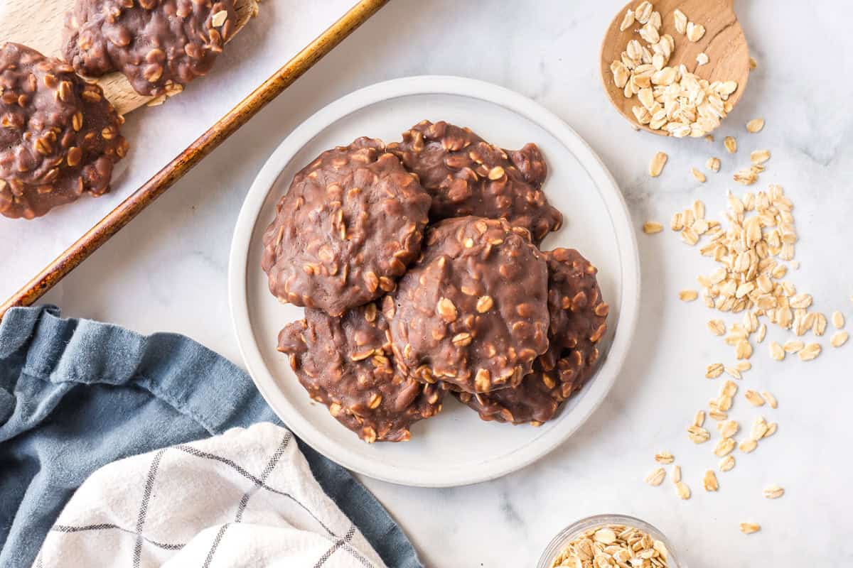 Chocolate peanut butter no bake cookies made with oats and cocoa. Easy, fudgy and perfect for a no-oven summer dessert! plate of chocolate peanut butter no bake cookies