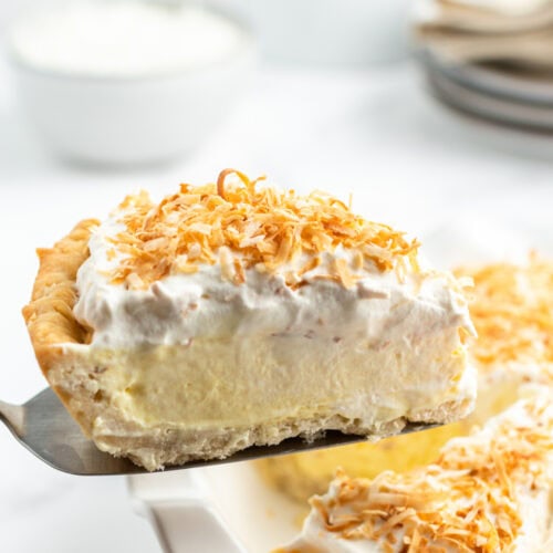 spatula holding up slice of coconut cream pie