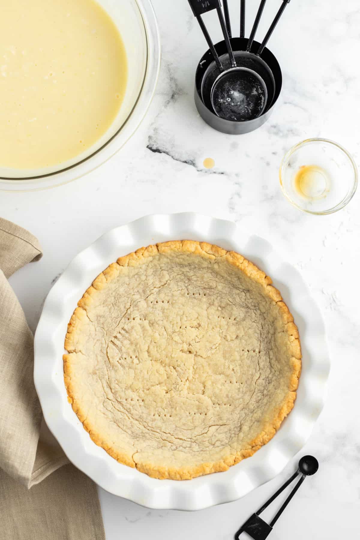 Coconut Cream Pie with a rich custard filling, whipped cream and toasted coconut. A classic homemade dessert that’s totally worth it. pie crust in pie plate