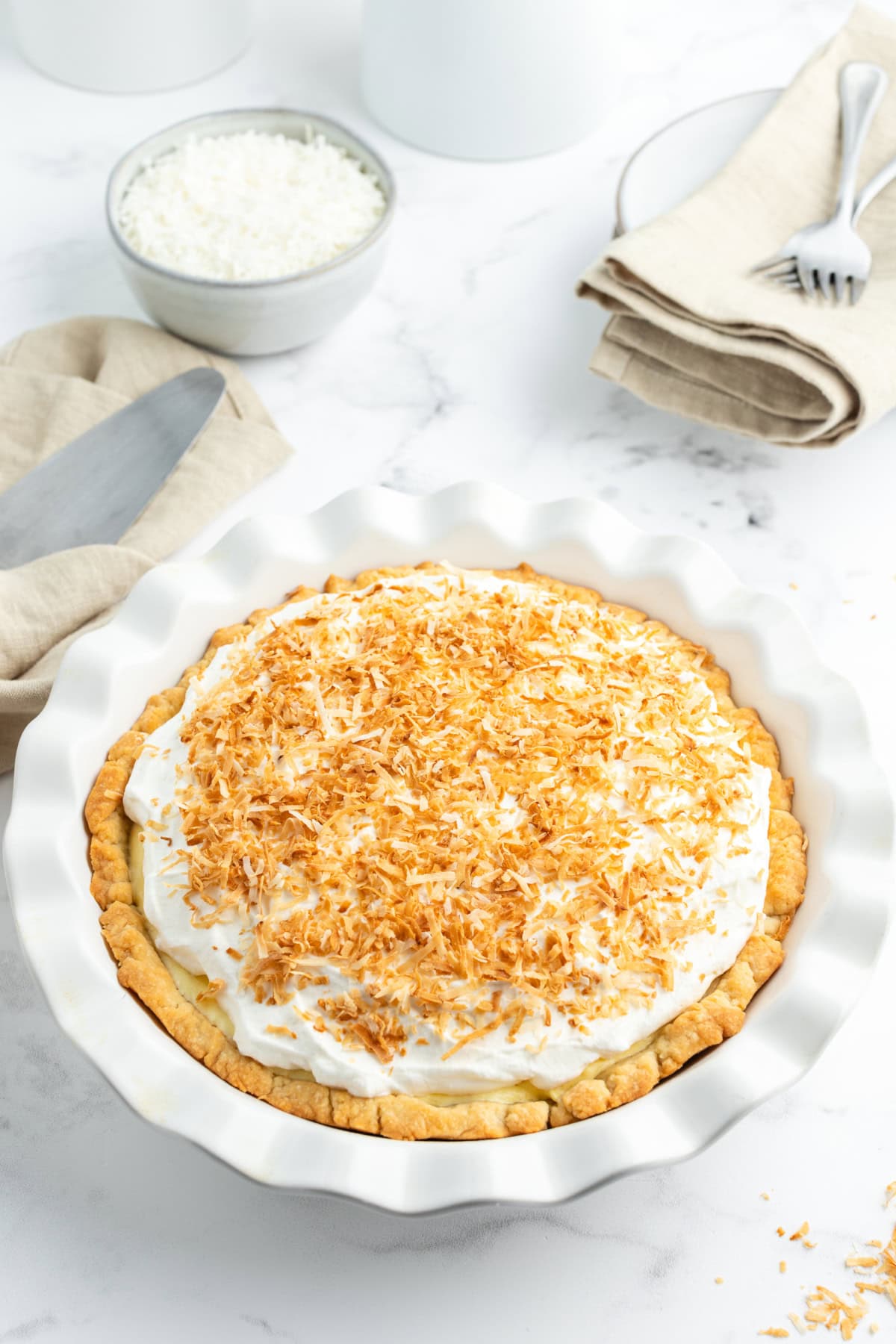 Coconut Cream Pie with a rich custard filling, whipped cream and toasted coconut. A classic homemade dessert that’s totally worth it. coconut cream pie