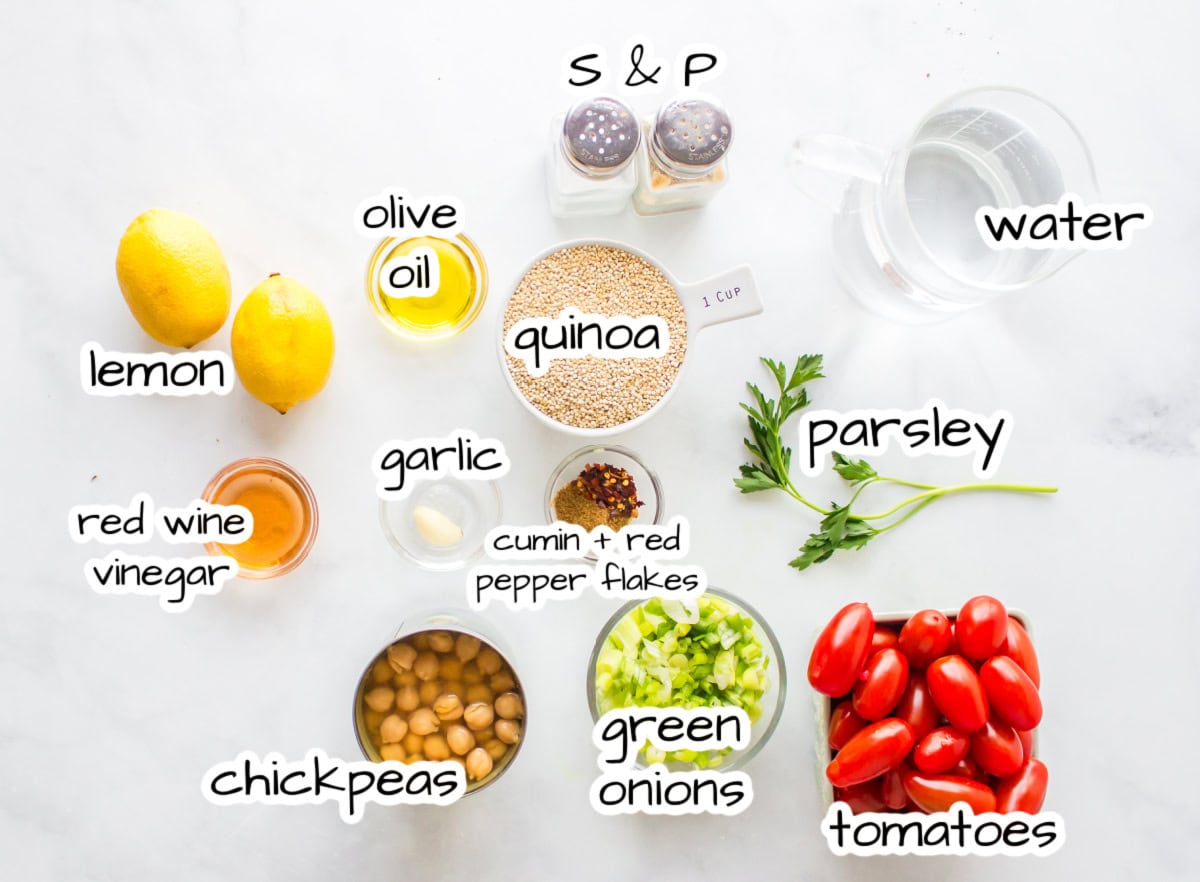Easy quinoa salad with chickpeas, tomatoes and a lemon dressing. Fresh, healthy and perfect for meal prep or a quick meal! ingredients displayed for making easy quinoa salad
