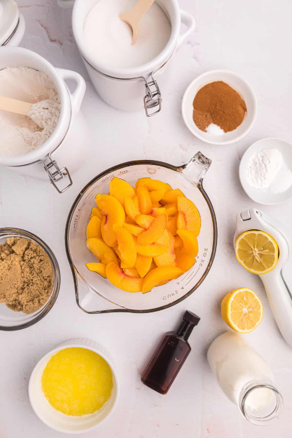 This Easy Peach Cobbler is packed with sweet peaches, warm cinnamon and nutmeg, and a buttery golden topping that tastes amazing with vanilla ice cream. Made with fresh or frozen peaches, it's the perfect summer dessert recipe for family gatherings, potlucks and holidays. Save this homemade peach cobbler recipe for later! #peachcobbler #peachdessert #summerdesserts #bakingrecipes #comfortfood ingredients displayed for making easy peach cobbler
