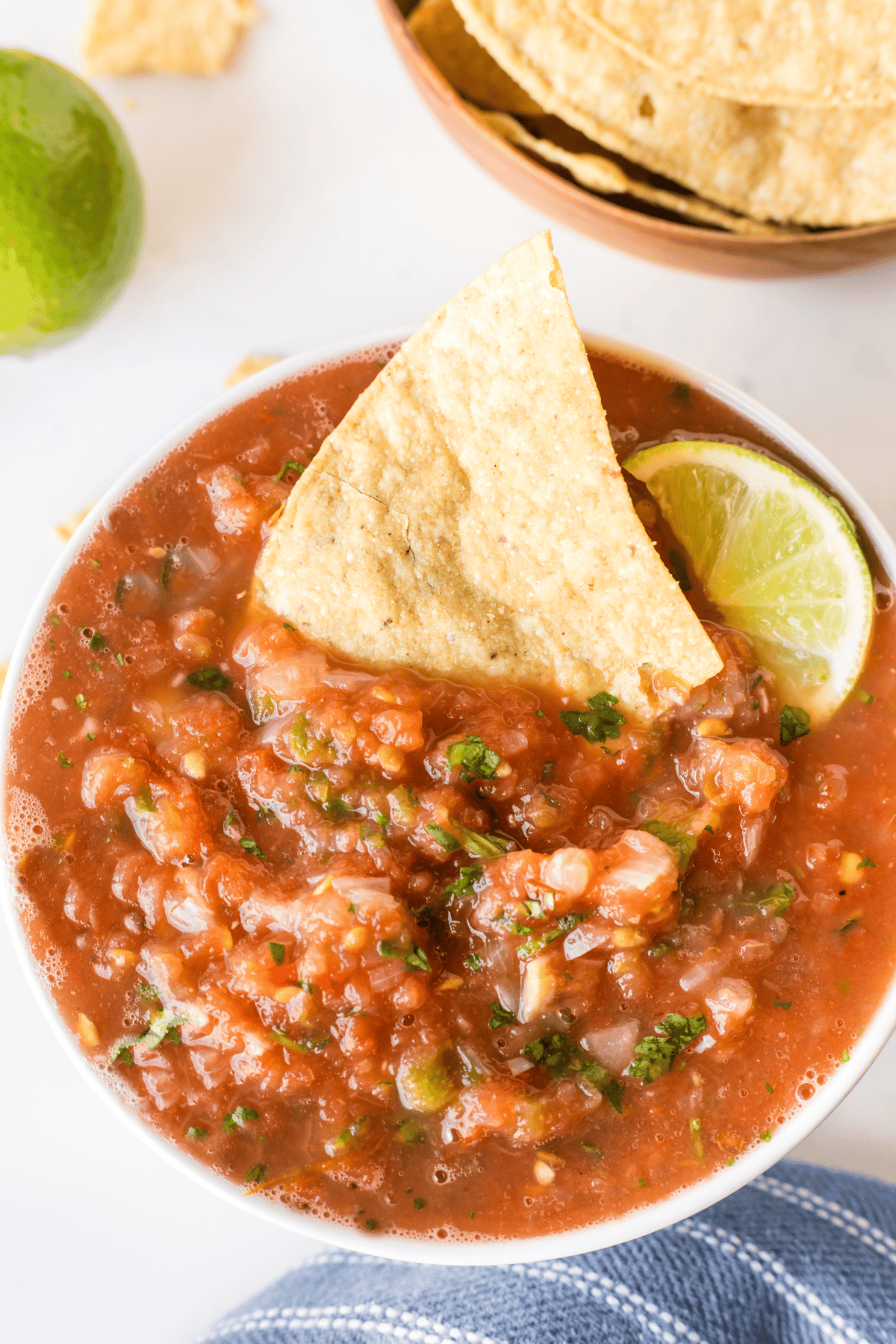 chip sitting in bowl of restaurant style salsa