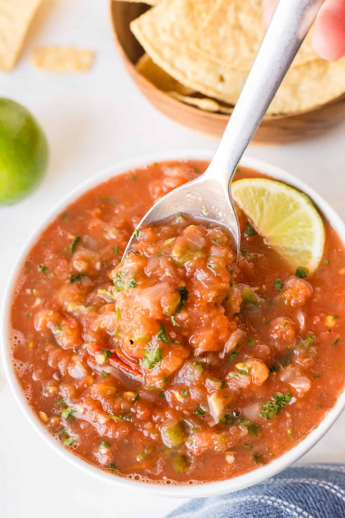 spooning out restaurant style salsa out of bowl
